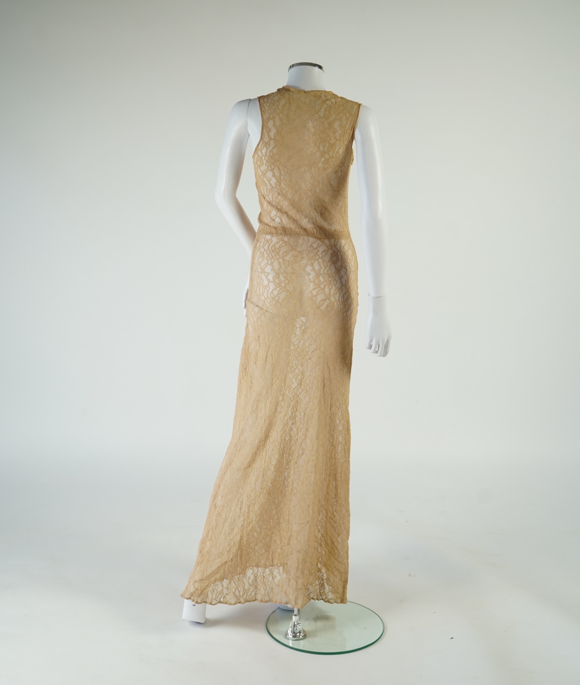 A flesh coloured 1930s lace evening dress and matching jacket together with a bottle green velvet evening dress and buckle belt and an unusual green shot silk pleated under skirt. Lace dress bust 32 inches. 156cm long. C